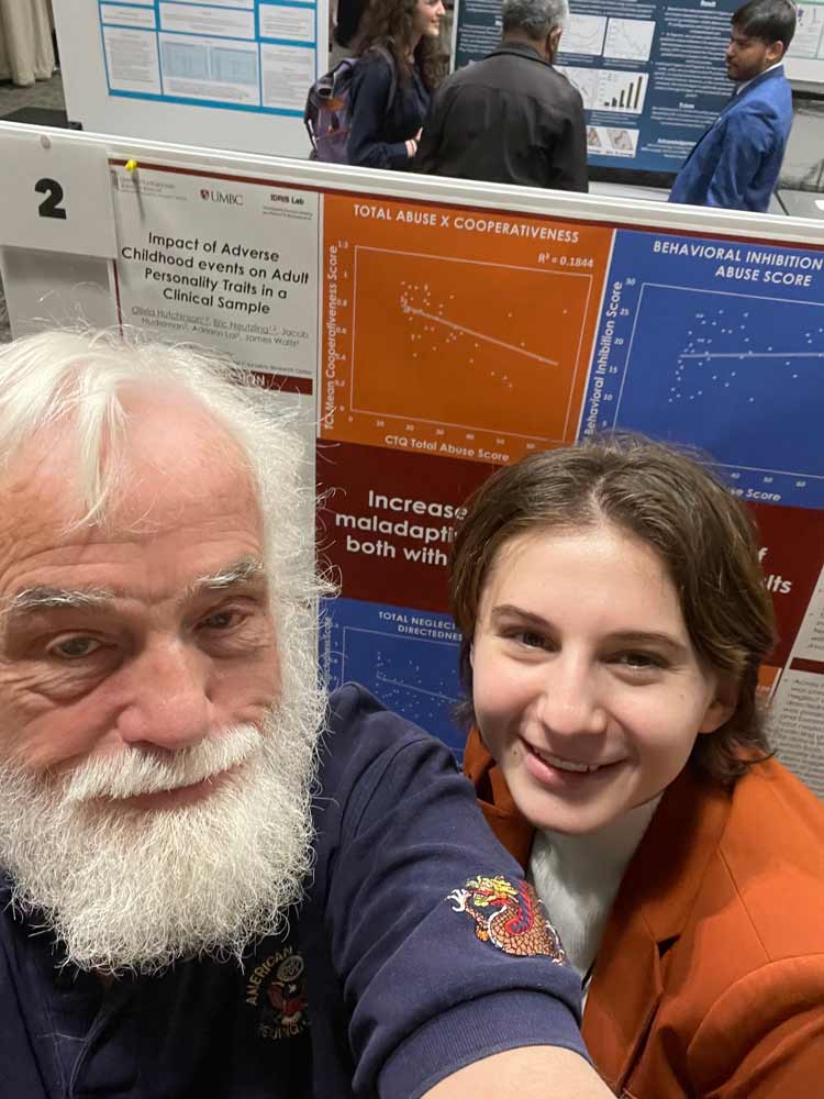 A student taking a picture with her grandfather
