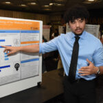 A young man presenting his research