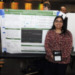A young undergraduate researcher presenting her research to the public