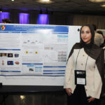 A young undergraduate researcher presenting her research to the public