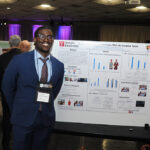 A young undergraduate researcher presenting his research to the public