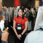 A young undergraduate researcher presenting her research to the public