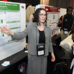 A young undergraduate researcher presenting her research to the public