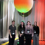 Four young undergraduate researchers standing in front of their hot air weather balloon
