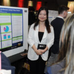 A young undergraduate researcher presenting her research to the public