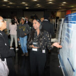 A young undergraduate researcher presenting her research to the public