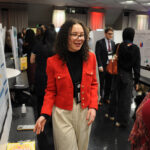 A young undergraduate researcher presenting her research to the public