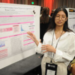 A young undergraduate researcher presenting her research to the public