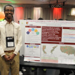 A young undergraduate researcher presenting his research to the public